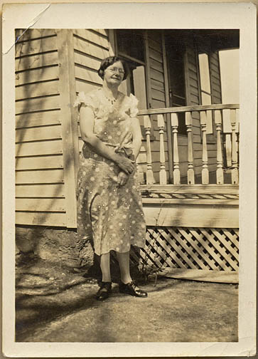 Della stands near the front porch in 1930