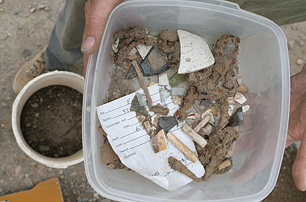 artifacts held in plastic tub