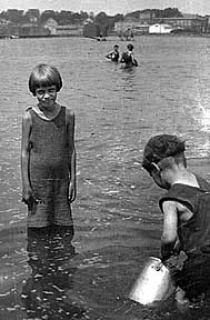 Margaret in the water up to her knees with her brother nearby