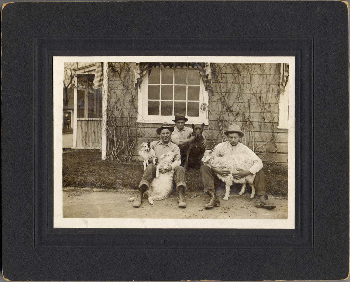 Early 1900s brothers with their favorite family pets. Stamped on the back of the photo with 'PHOTO BY BROWNING LITTLETON COLORADO'.